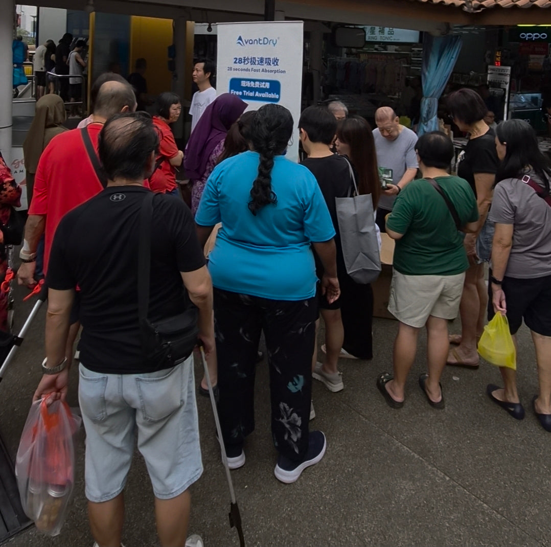 Group of people lining up outdoors to see the AvantDry live demonstration Singapore heartlands